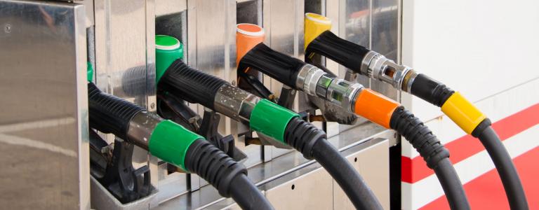 A row of pump handles at a gas station