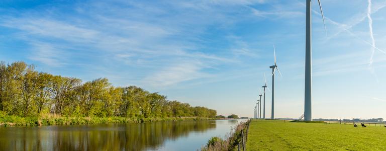 Windpark on dike, blue sky