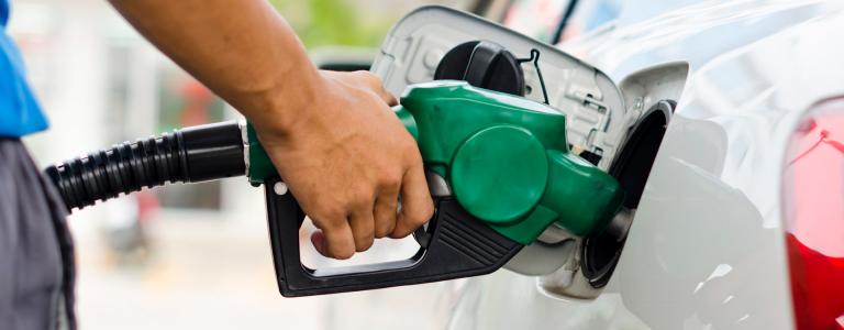 A man pumping gas into a car