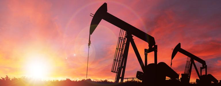 Two pump jacks in rural Alberta, Canada, at sunset