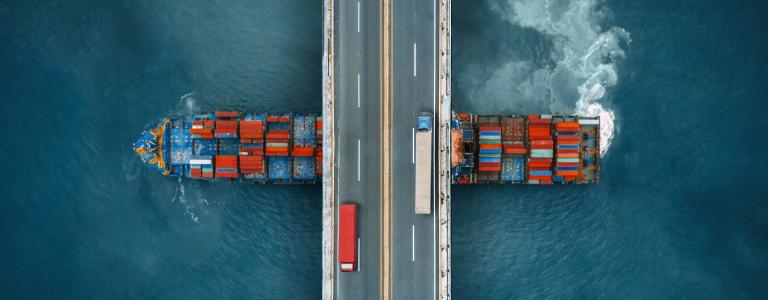 Trading ship under bridge