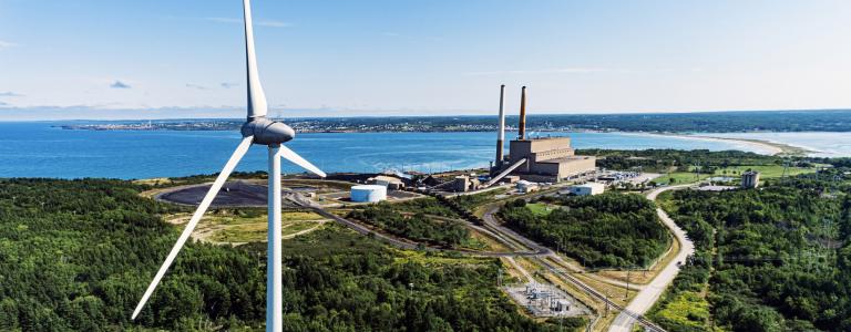 Wind turbine next to power plant