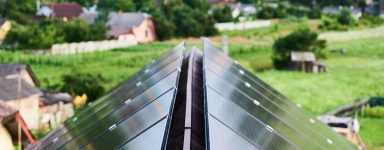 Closeup of a rooftop with solar panels in an urban landscape