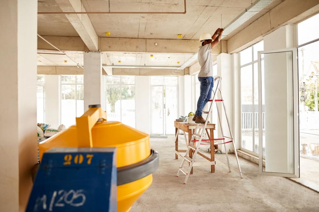 An engineer fixes wiring in a ceiling of a work site