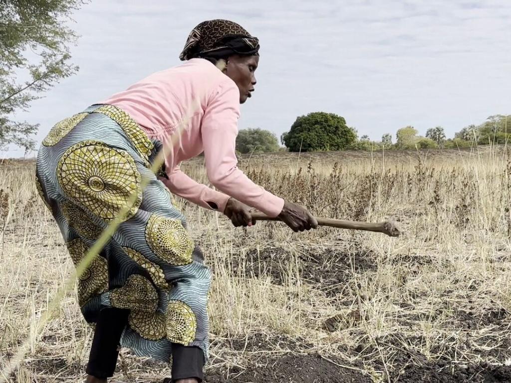 A woman works to restore the Nsongwe River